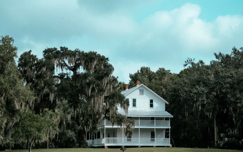 White farmhouse under live oaks near Bastrop