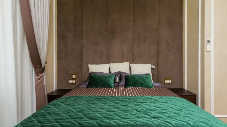 Bedroom with a made bed and upholstered headboard, bed bug treatment in Monroe
