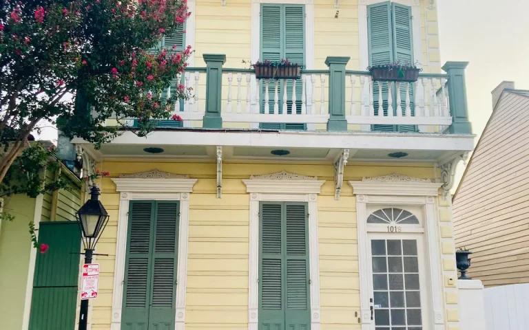 Yellow two-story home with balcony in Ruston, LA