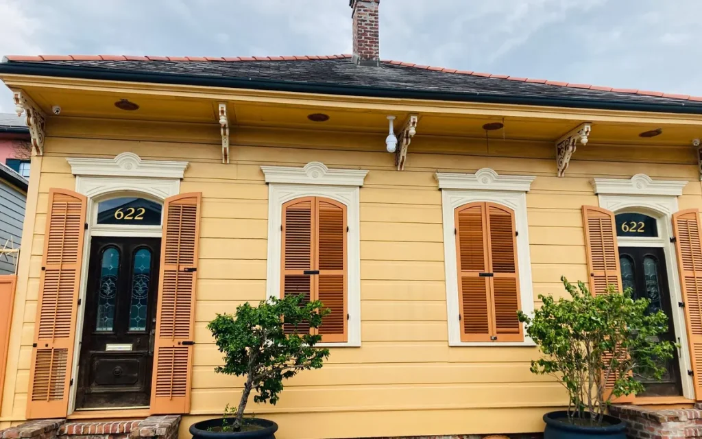 Yellow cottage home with shutters in Ruston