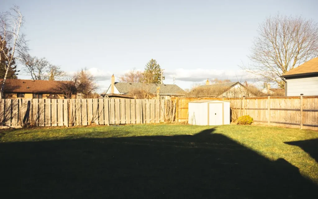 Fenced backyard with a shed in Swartz